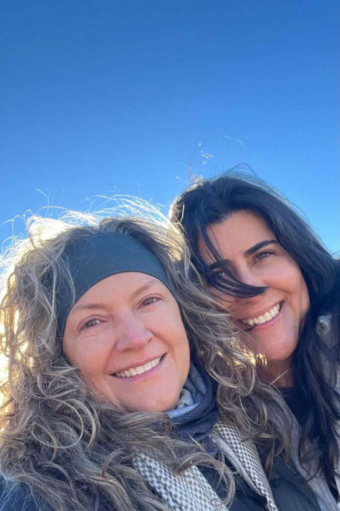 Dos-mujeres-riendo-fondo-cielo-azul